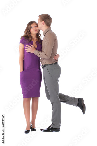 Young couple kissing against a white background