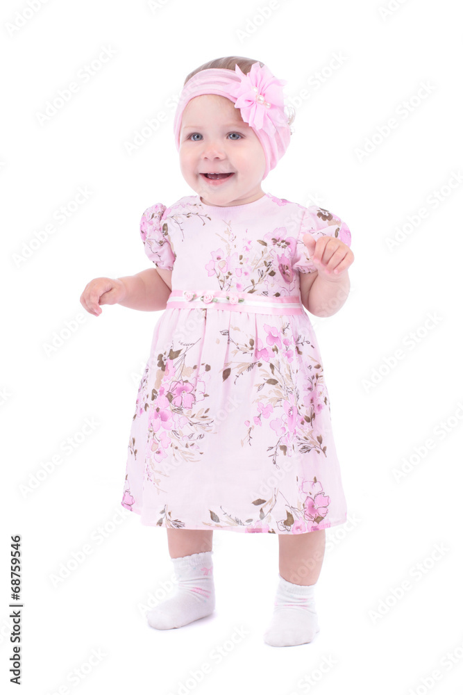 Small smiling baby girl in pink dress over white background Small smiling baby girl in pink dress over white background