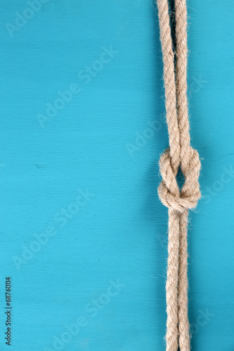 Marine knot on color wooden background