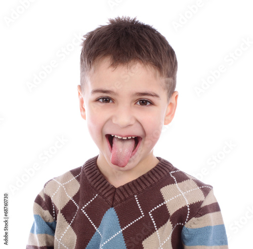 Little naughty boy portrait sticking out his tongue over white b