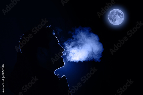 Man exhaling warm breath photo