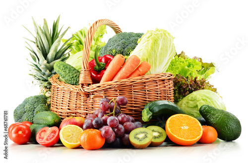 Wicker basket with groceries isolated on white