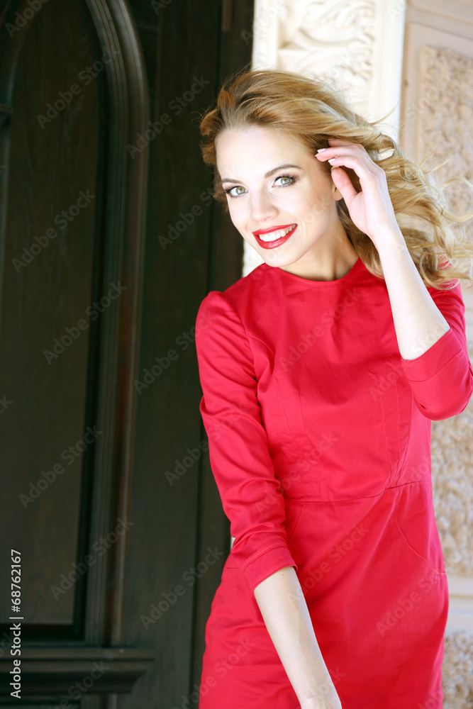 Beautiful young girl outdoors near building