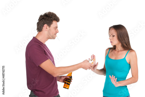 Drunk man gives alcohol to girl.
