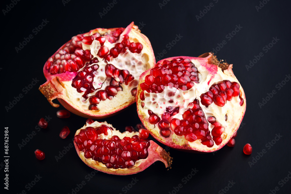 Ripe pomegranate fruit on black background Ripe pomegranate fruit on black background