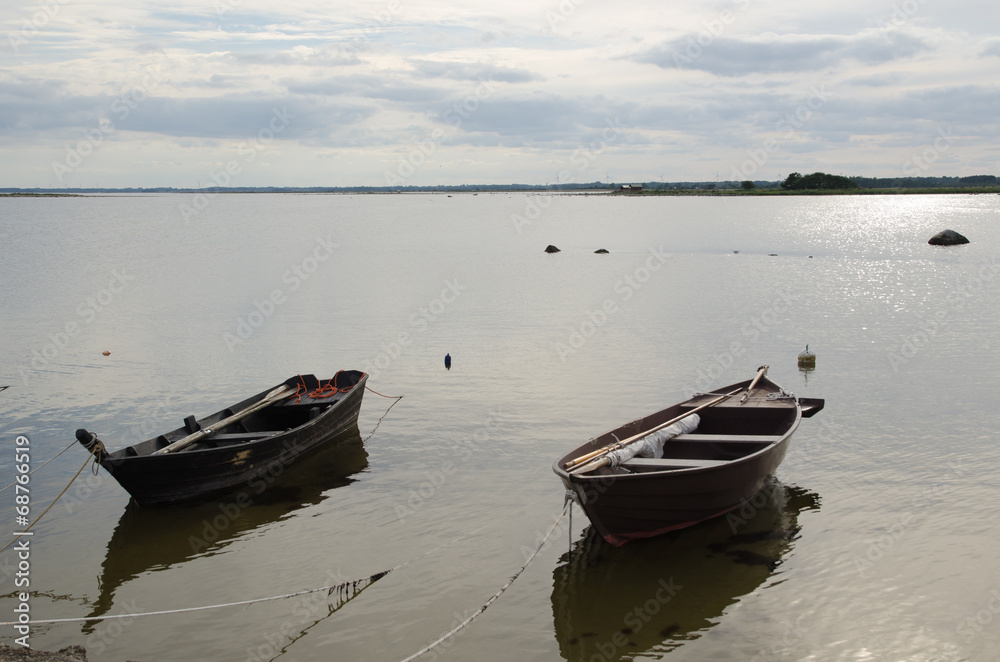Two old wooden rowing boats by the coast