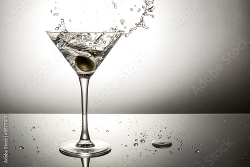 Olive splashing on martini
