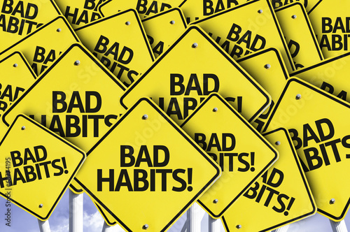 Bad Habits! written on multiple road sign
