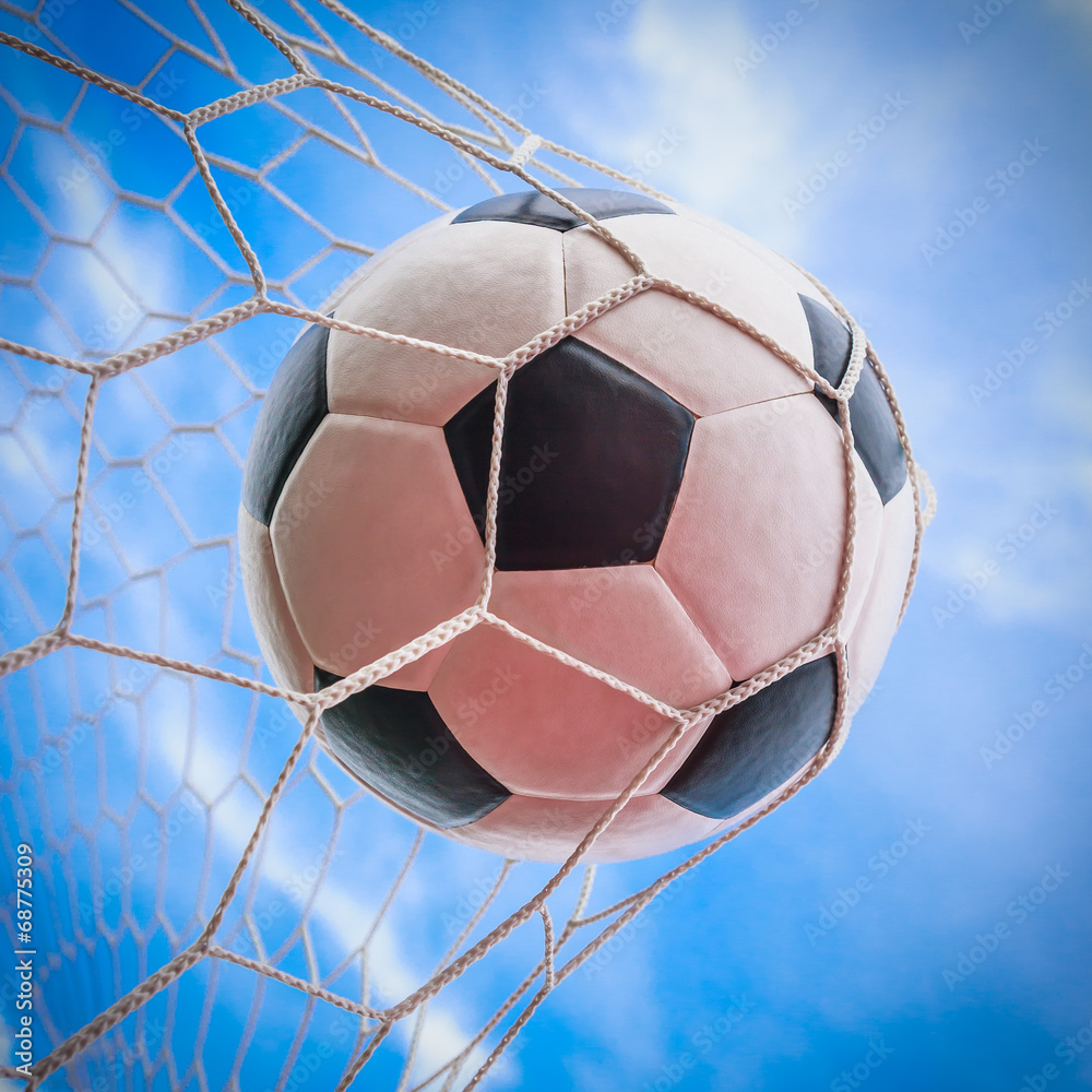 Naklejka premium soccer ball in goal net