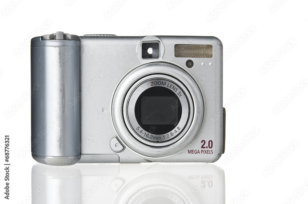 Old-fashioned dirty compact photo camera on white background