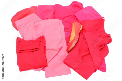 Heap of red and pink clothes with womanly shoes