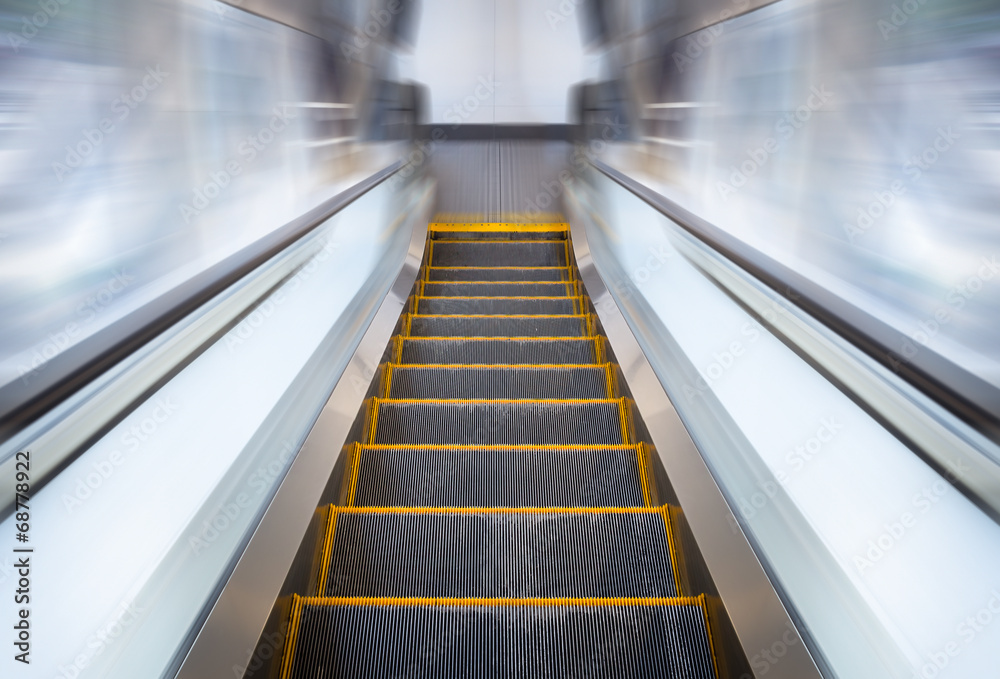 Empty escalator or moving stair. Also called stairway or staircase. Modern architecture design with step, glass for lift people up floor building i.e. shopping mall, airport, metro and subway station. Empty escalator or moving stair. Also called stairway or staircase. Modern architecture design with step, glass for lift people up floor building i.e. shopping mall, airport, metro and subway station.