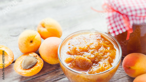 apricot fruits and jar of jam on table