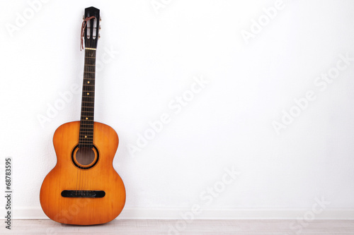Guitar on the floor on white background
