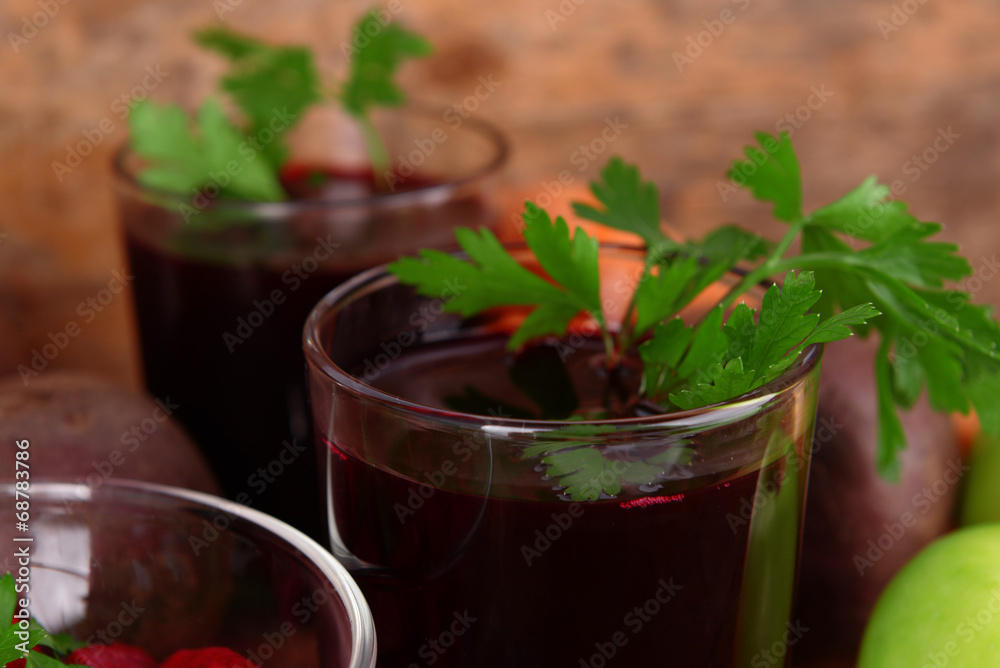 Glasses of fresh beet juice and vegetables on wooden background Glasses of fresh beet juice and vegetables on wooden background