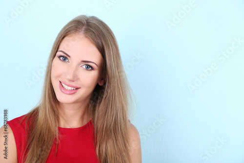 Beautiful young girl in dress on color background