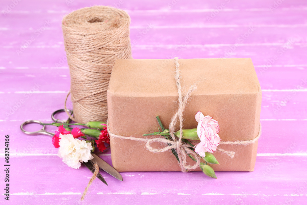Beautiful gift with flowers and decorative rope, Beautiful gift with flowers and decorative rope,