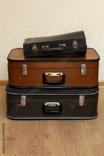 Vintage old travel suitcases on floor