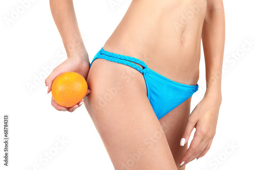 Young woman with orange isolated on white