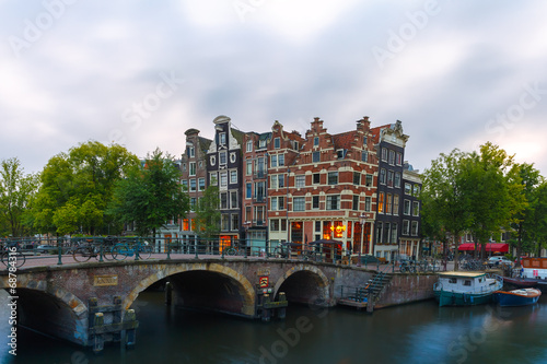 Dusk city view of Amsterdam canal and bridge