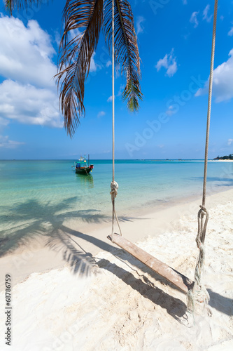 Fototapeta Naklejka Na Ścianę i Meble -  swing, palm tree shadow, boat,  beach