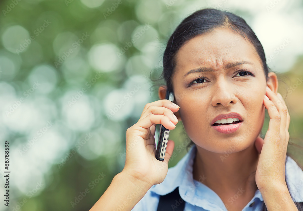 Unhappy, stressed woman talking on mobile phone outside Unhappy, stressed woman talking on mobile phone outside