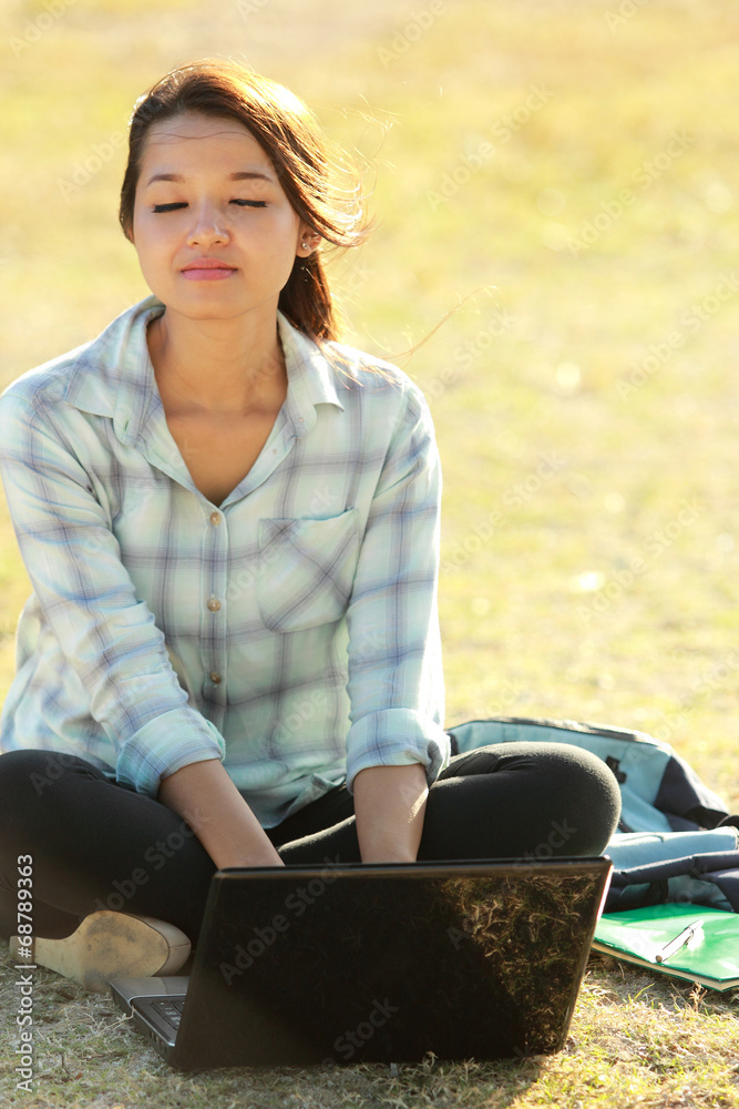 girl sitting with laptop and books