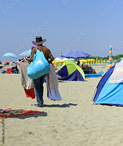 abusive salesman dressed on the beach