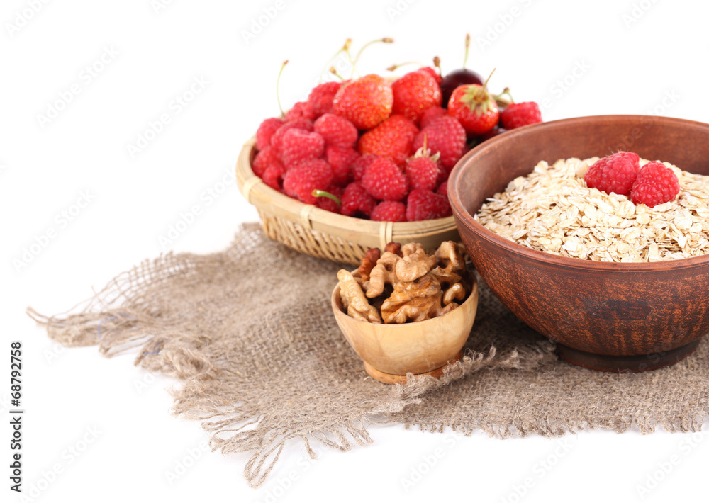 Wooden bowls of berries on sackcloth isolated on white Wooden bowls of berries on sackcloth isolated on white