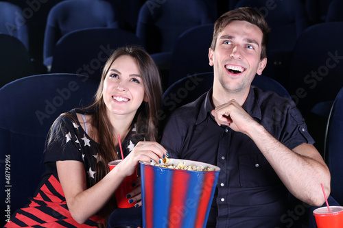 Young couple watching movie...