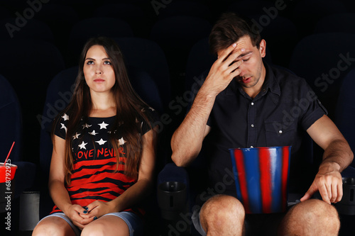 Young couple watching movie...