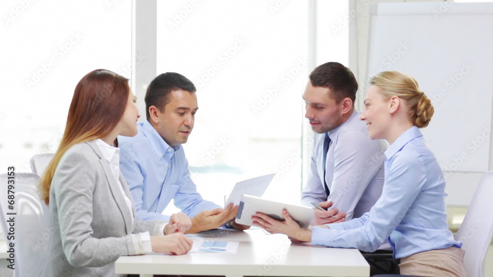 smiling team with table pc and papers working smiling team with table pc and papers working