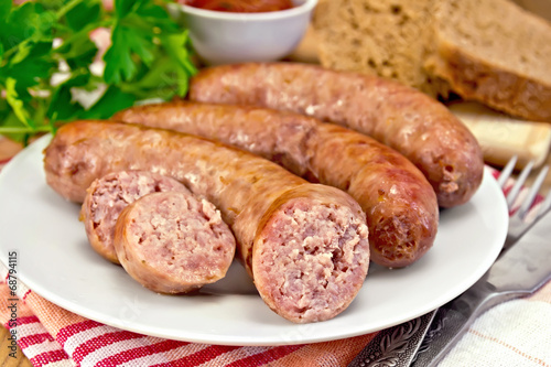 Sausages pork fried in plate on board with parsley