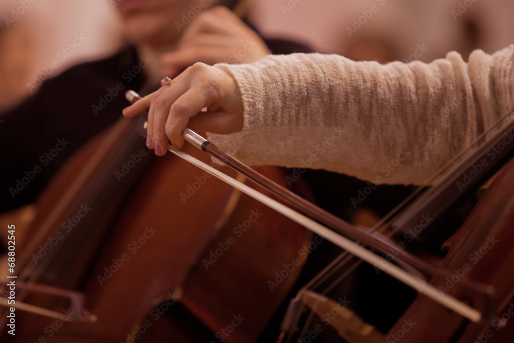 Hand girl playing cello closeup Hand girl playing cello closeup
