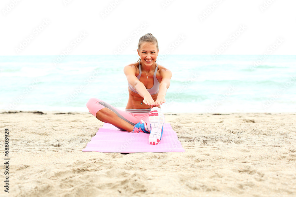 cheerful girl working out on the beach.