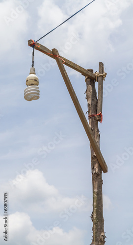 Lamp, bulb and a wooden pole.