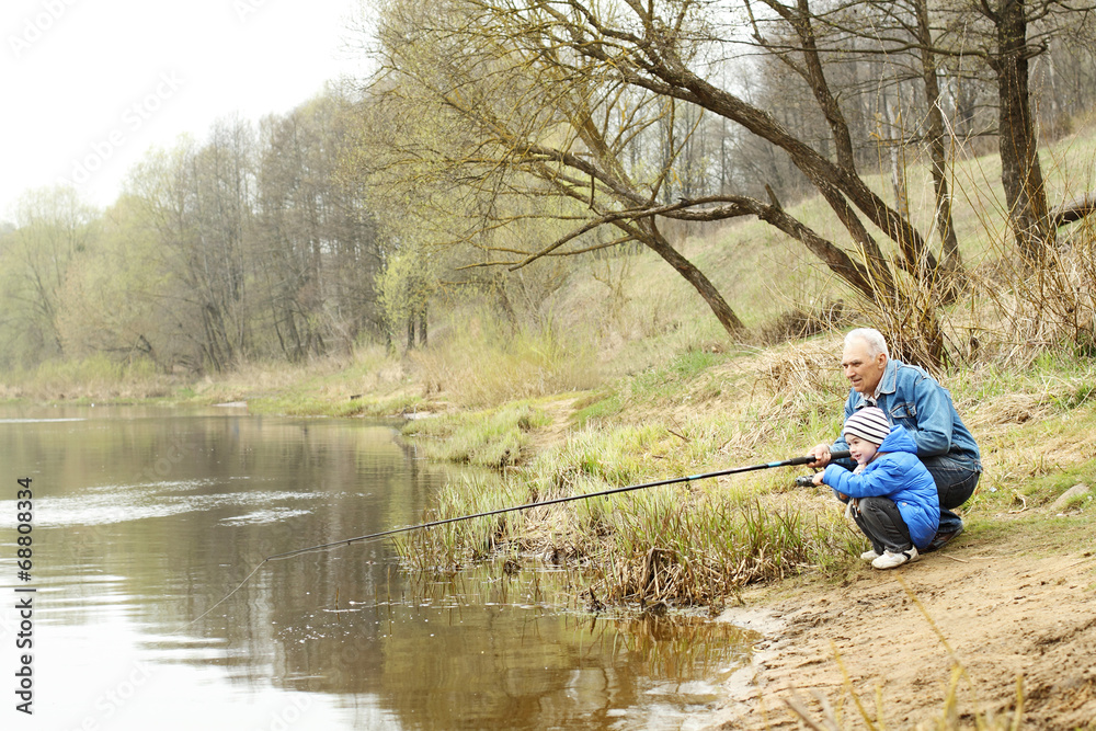 Grandfather and grandson are fishing Grandfather and grandson are fishing