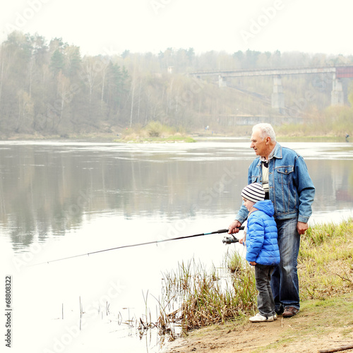 Grandfather and grandson are fishing