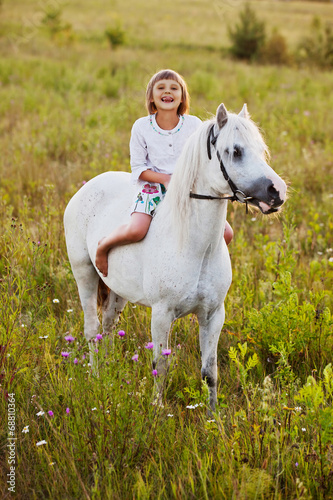 Little girl riding a horse