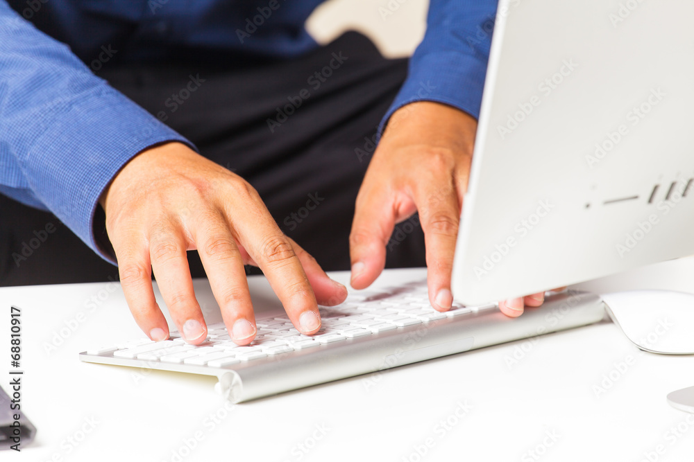 male hands typing on computer keyboard male hands typing on computer keyboard