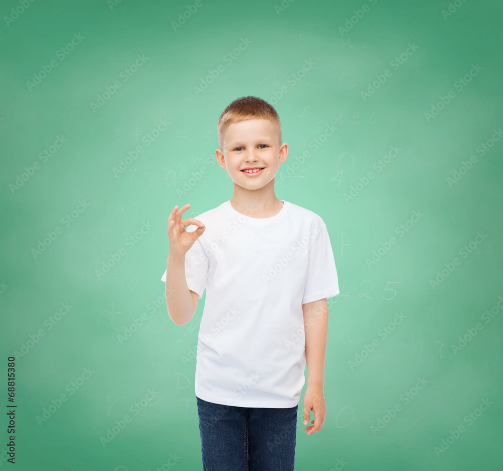 little boy in white t-shirt making ok gesture