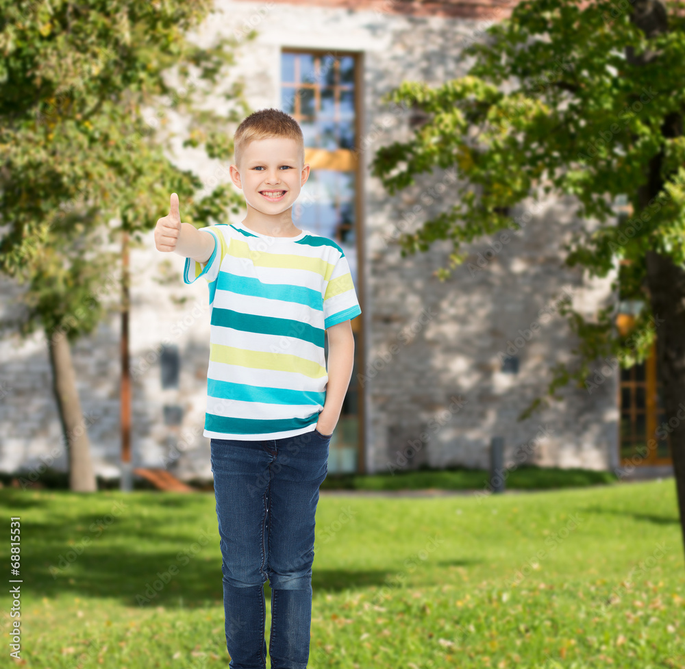 smiling little boy showing thumbs up smiling little boy showing thumbs up