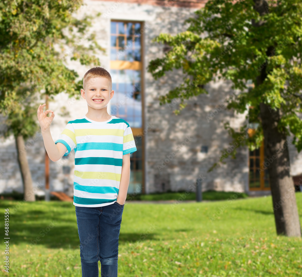 smiling little boy showing ok sign