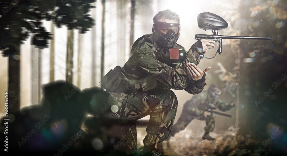Fototapeta premium Paintball team in action forest location