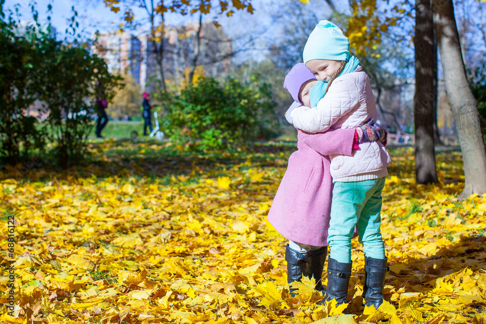Two adorable little girls enjoying autumn sunny day Two adorable little girls enjoying autumn sunny day