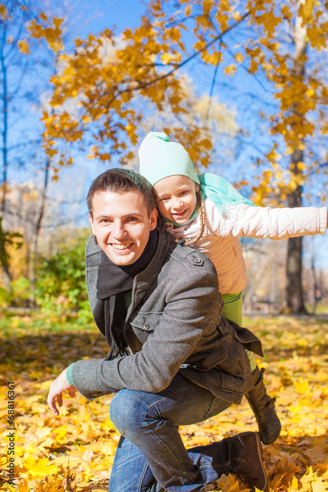Portrait of happy father with his cute daughter in autumn park Portrait of happy father with his cute daughter in autumn park