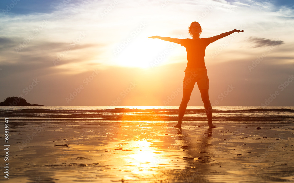Silhouette of woman exercise on the beach at sunset.