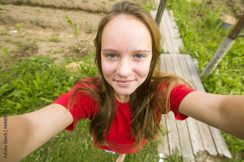 Teengirl taking a selfie out in the country house. Teengirl taking a selfie out in the country house.