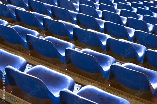 empty blue seats at sports stadium