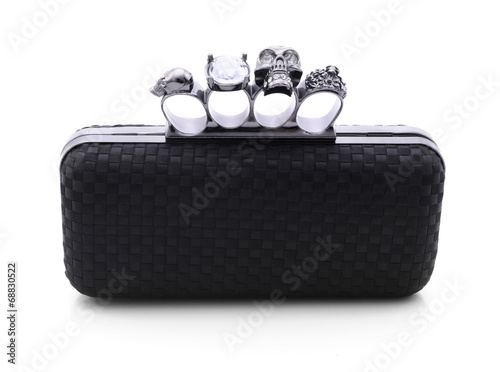 Black handbag brass knuckles and a skull on a white background
